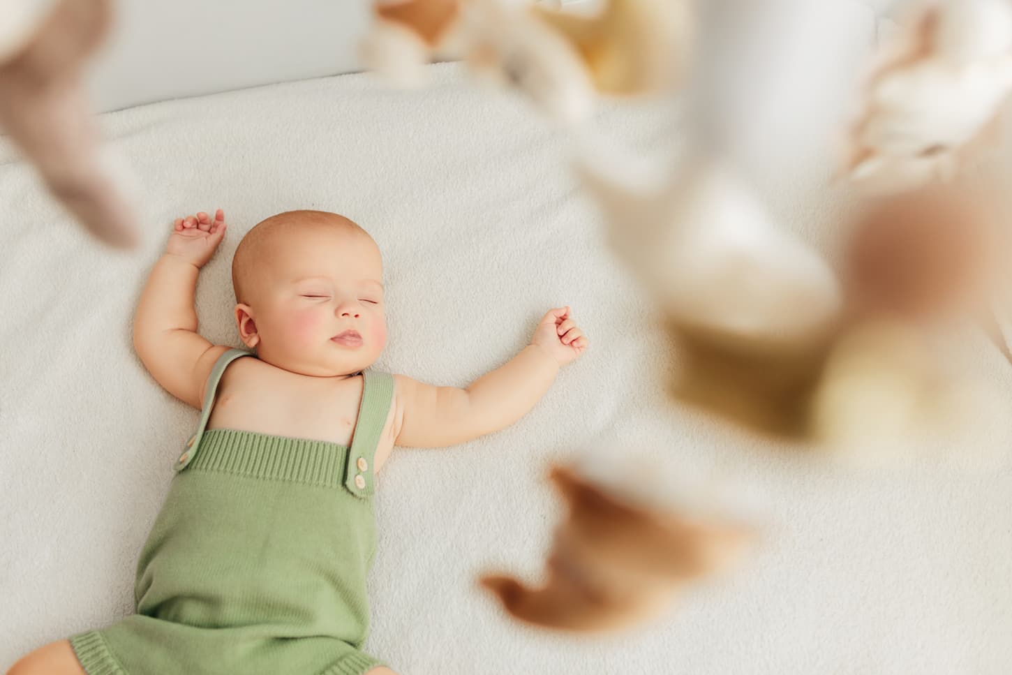 An image of a baby soundly sleeping in a crib.