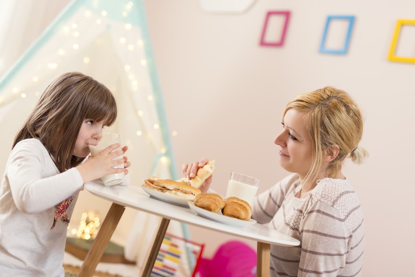 An image of a mother and her daughter having breakfast together.