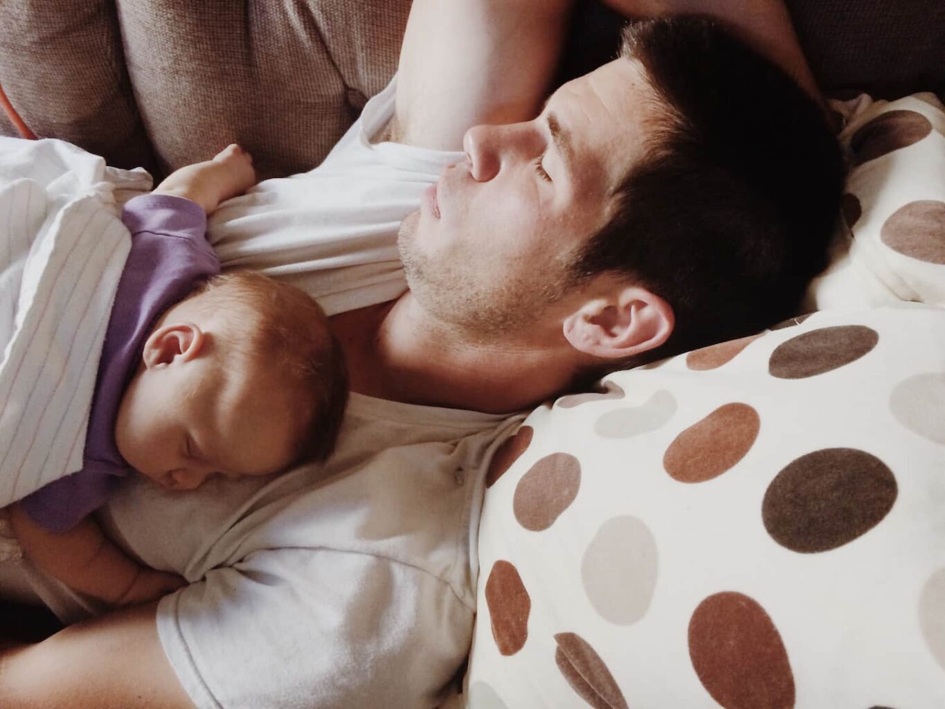 An image of a father and child having an afternoon nap.